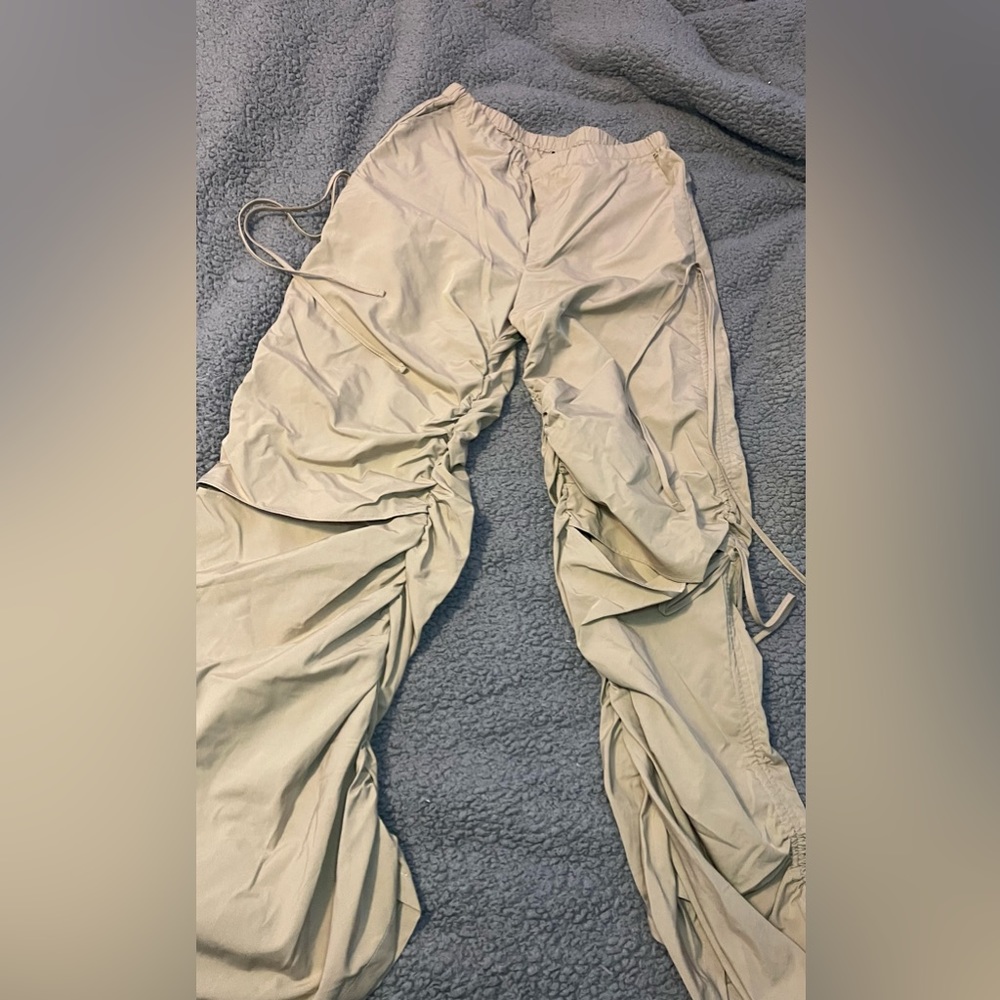 Tan trousers with adjustable ties at the sides. Worn only once. Still brand new!